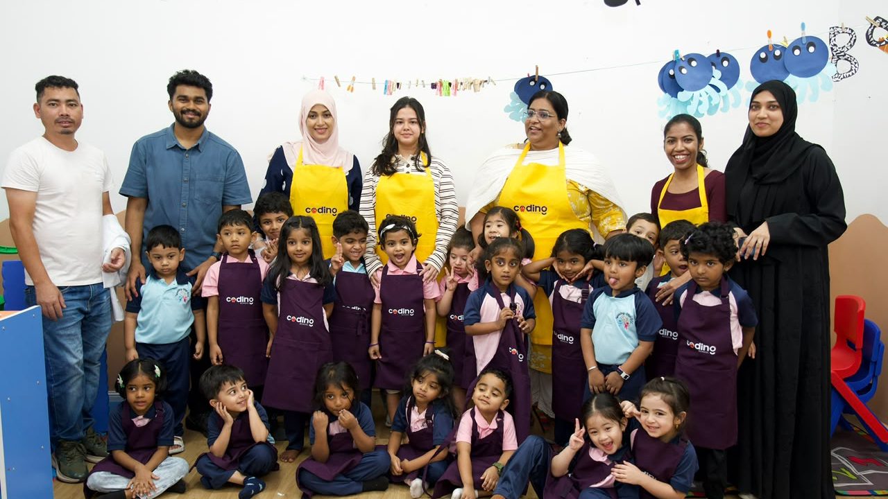 A full group photo of nursery children, parents and Coding School facilitators after a Tinker Fair.