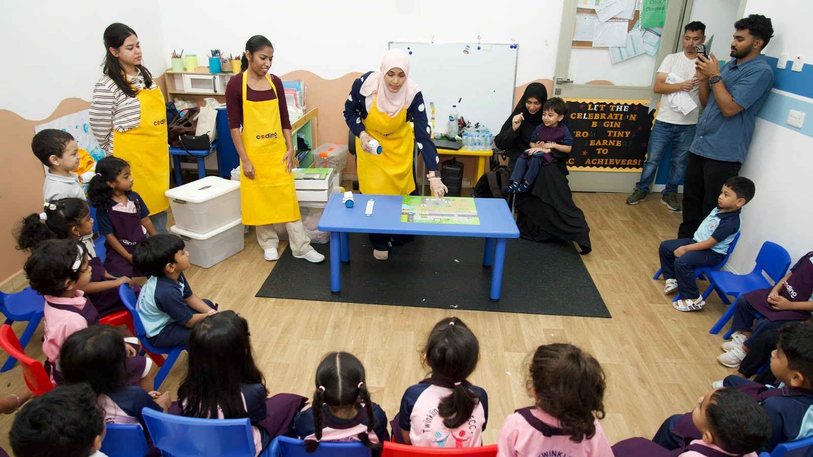 Wide view of a nursery classroom during a Coding School enrichment session.